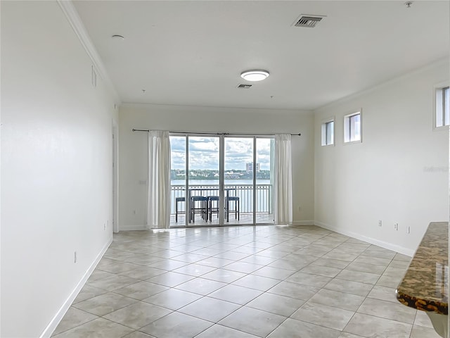 8743 S The Esplanade Unit 18, Orlando, FL 32836 - spare room with crown molding, light tile patterned flooring, and a water view