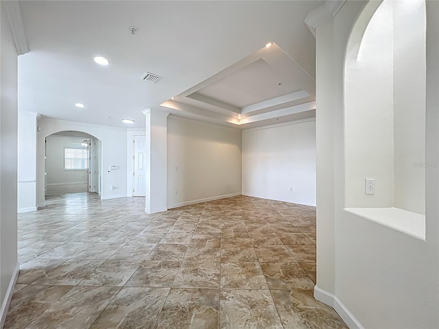 8743 S The Esplanade Unit 18, Orlando, FL 32836 - empty room with arched walkways, a pendent fire sprinkler, recessed lighting, and a tray ceiling