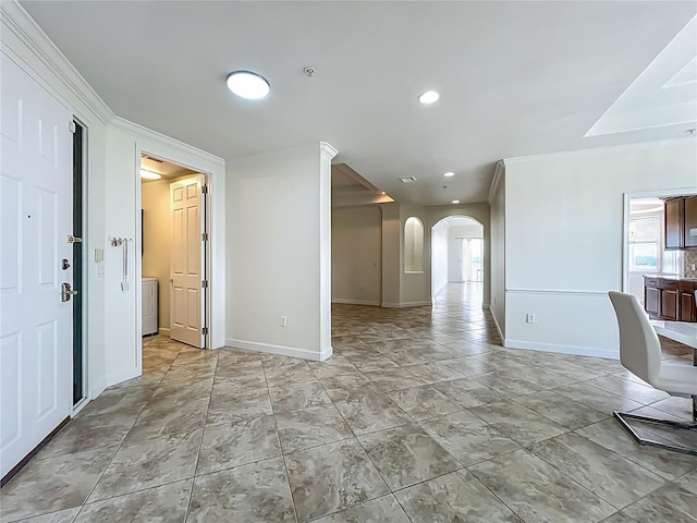 8743 S The Esplanade Unit 18, Orlando, FL 32836 - unfurnished living room with arched walkways, washer / clothes dryer, and recessed lighting