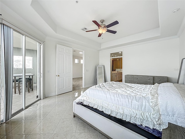 8743 S The Esplanade Unit 18, Orlando, FL 32836 - bedroom with a tray ceiling, access to exterior, ceiling fan, and ensuite bath