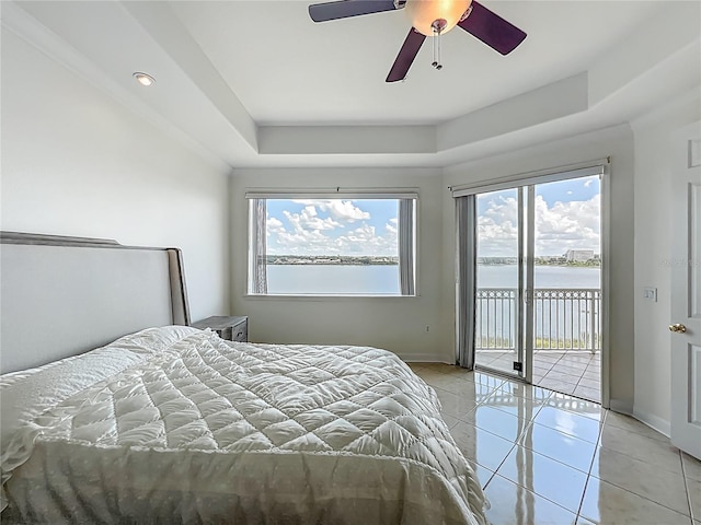 8743 S The Esplanade Unit 18, Orlando, FL 32836 - bedroom with access to exterior, a raised ceiling, a water view, light tile patterned flooring, and a ceiling fan