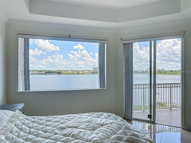 8743 S The Esplanade Unit 18, Orlando, FL 32836 - bedroom with access to outside, multiple windows, and a water view