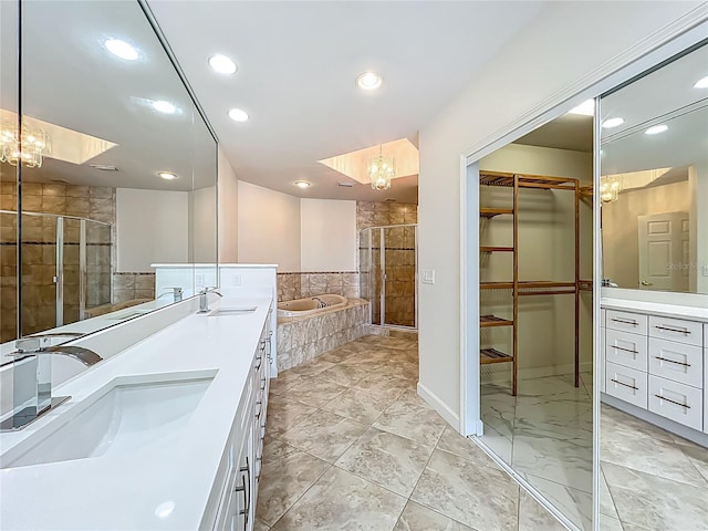 8743 S The Esplanade Unit 18, Orlando, FL 32836 - bathroom with double vanity, a bath, a shower stall, recessed lighting, and a spacious closet