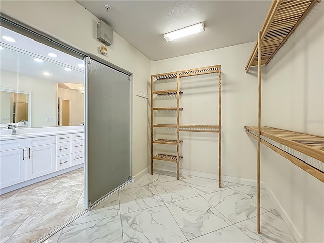 8743 S The Esplanade Unit 18, Orlando, FL 32836 - walk in closet featuring light marble finish flooring