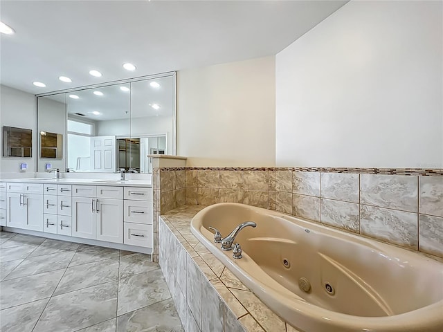 8743 S The Esplanade Unit 18, Orlando, FL 32836 - bathroom with double vanity, a tub with jets, and recessed lighting