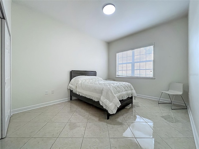 8743 S The Esplanade Unit 18, Orlando, FL 32836 - bedroom with baseboards and light tile patterned flooring