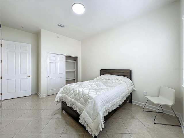 8743 S The Esplanade Unit 18, Orlando, FL 32836 - bedroom with a closet and light tile patterned floors