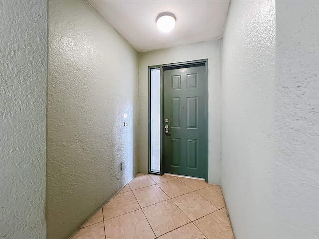 8743 S The Esplanade Unit 18, Orlando, FL 32836 - entryway with a textured wall and light tile patterned floors