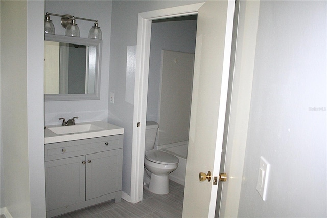 bathroom featuring toilet and vanity