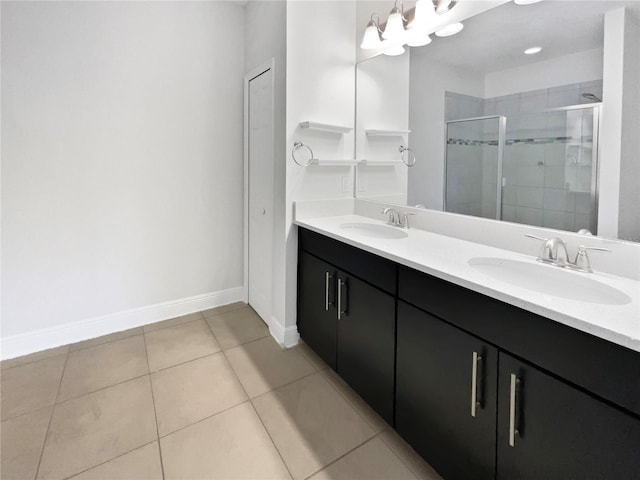 bathroom featuring a shower stall, tile patterned floors, double vanity, and a sink