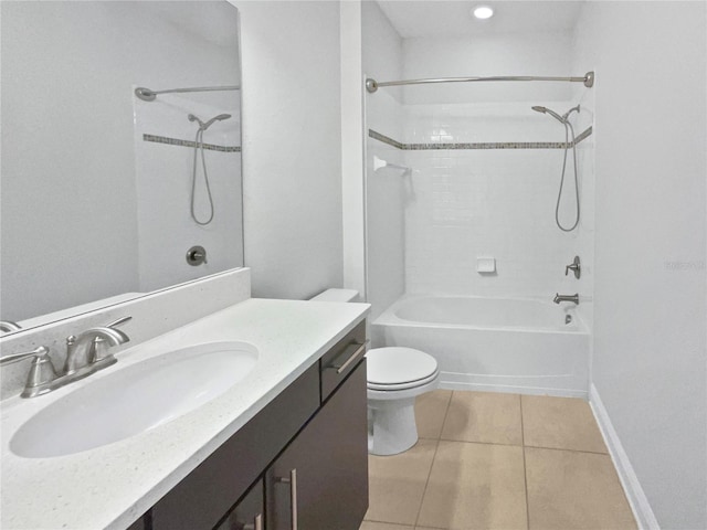 bathroom featuring tile patterned floors, toilet, vanity, shower / bathing tub combination, and baseboards