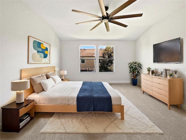 bedroom with light carpet, baseboards, lofted ceiling, and ceiling fan
