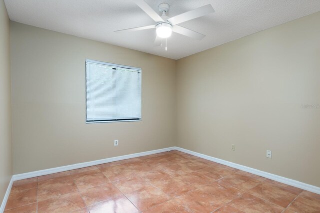 2132 Majestic Woods Blvd, Apopka, FL 32712 - unfurnished room featuring baseboards, ceiling fan, and a textured ceiling