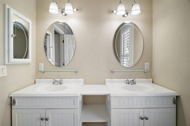bathroom with a sink and two vanities