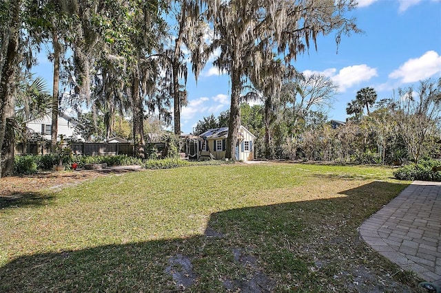 view of yard featuring an outbuilding and fence
