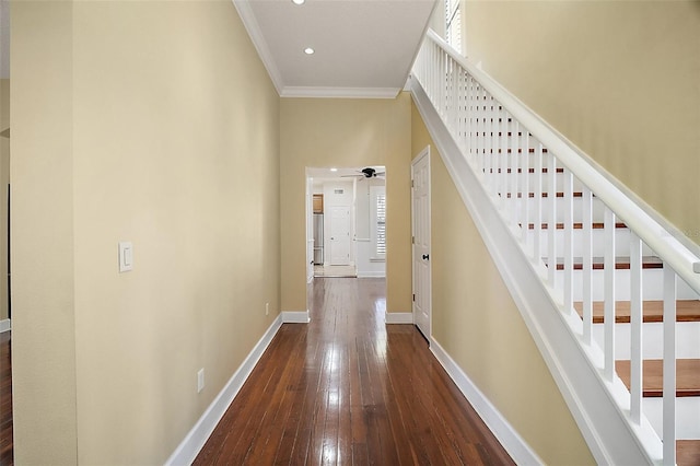 hall featuring baseboards, stairs, ornamental molding, recessed lighting, and wood-type flooring