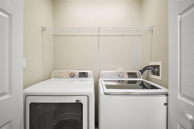 washroom featuring separate washer and dryer and laundry area