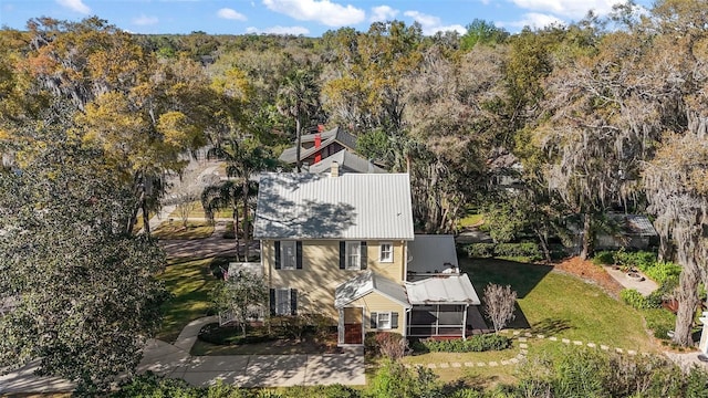 birds eye view of property with a view of trees