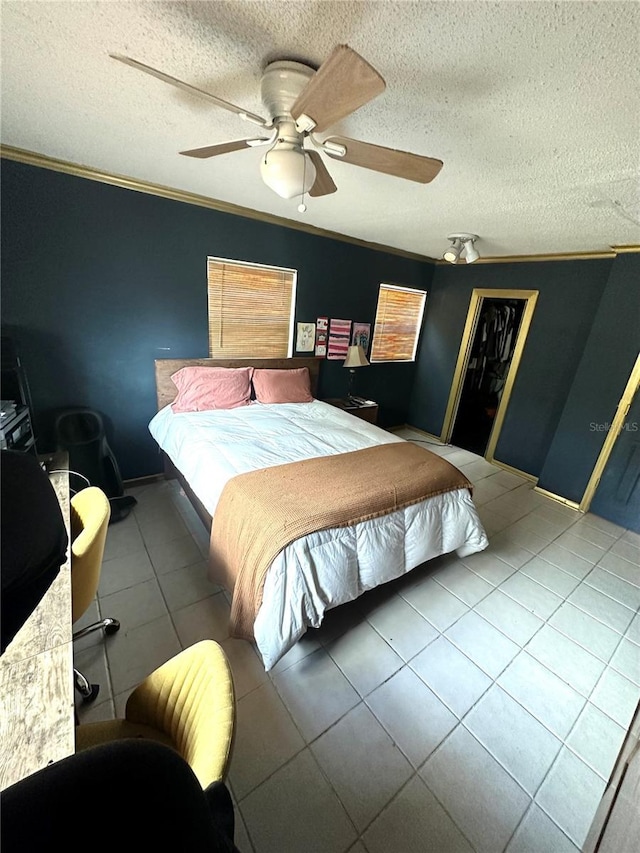1098 Henry Balch Dr, Orlando, FL 32810 - bedroom featuring a closet, ornamental molding, ceiling fan, a textured ceiling, and tile patterned floors
