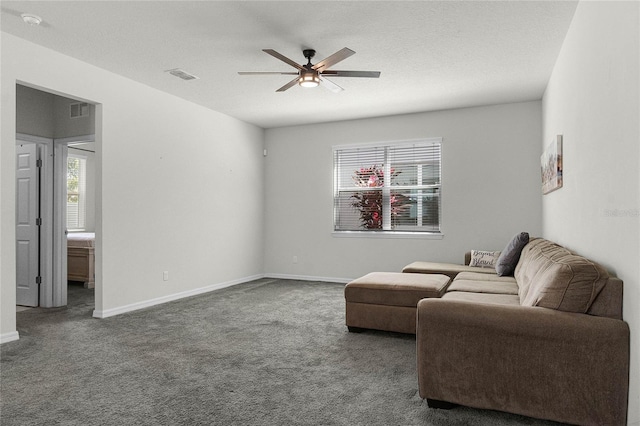 sitting room featuring baseboards, a ceiling fan, visible vents, and carpet floors
