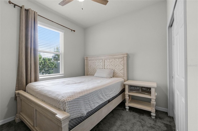 bedroom featuring dark colored carpet, baseboards, and ceiling fan