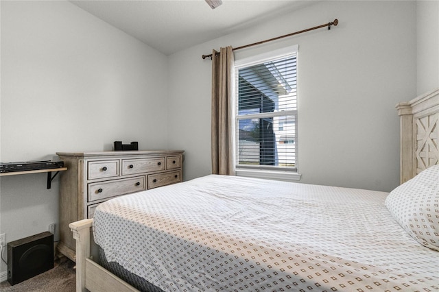 bedroom with carpet flooring and lofted ceiling