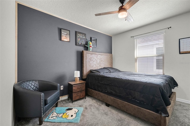 bedroom with a textured ceiling, baseboards, a ceiling fan, and carpet floors