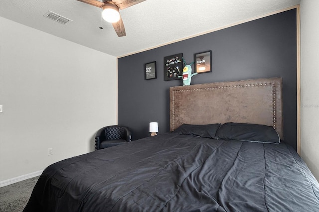 carpeted bedroom featuring visible vents, baseboards, and ceiling fan