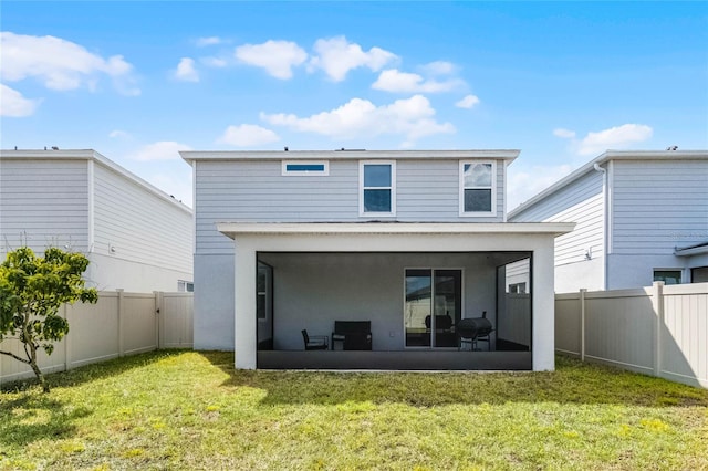 rear view of property with a sunroom, a fenced backyard, stucco siding, and a lawn