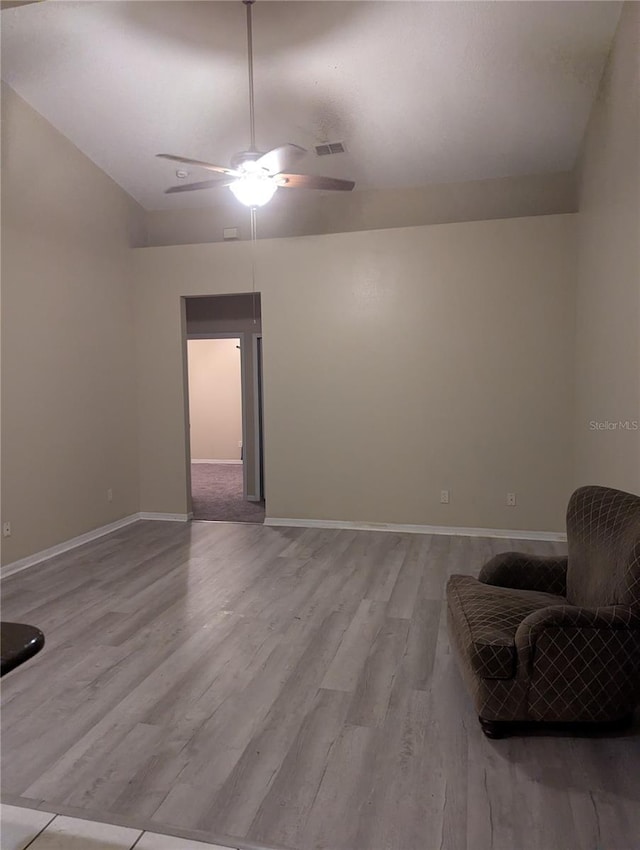 sitting room featuring baseboards, ceiling fan, visible vents, and wood finished floors