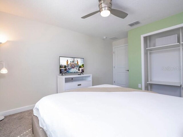 428 Ocean Course Ave, Davenport, FL 33896 - bedroom with carpet, baseboards, a closet, and a ceiling fan