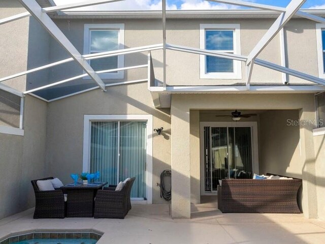 428 Ocean Course Ave, Davenport, FL 33896 - back of property featuring stucco siding, a patio area, ceiling fan, and an outdoor pool