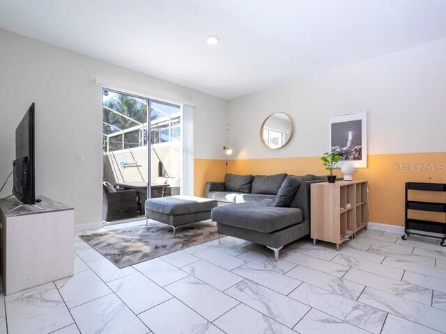 428 Ocean Course Ave, Davenport, FL 33896 - living room featuring light marble finish flooring and baseboards