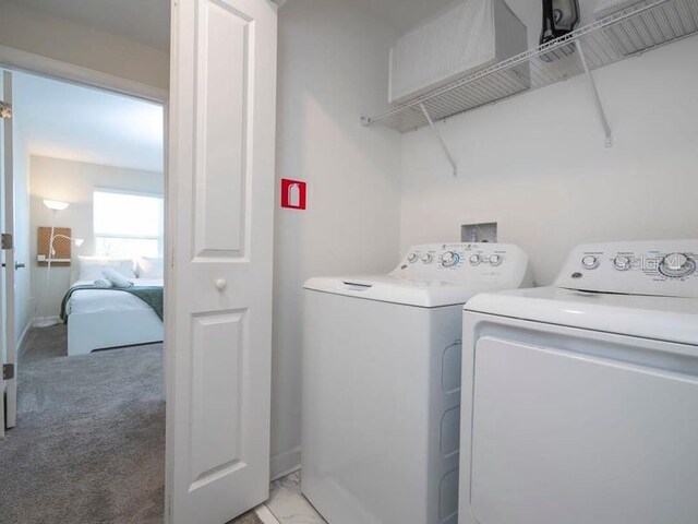 428 Ocean Course Ave, Davenport, FL 33896 - laundry room featuring washer and dryer and light colored carpet