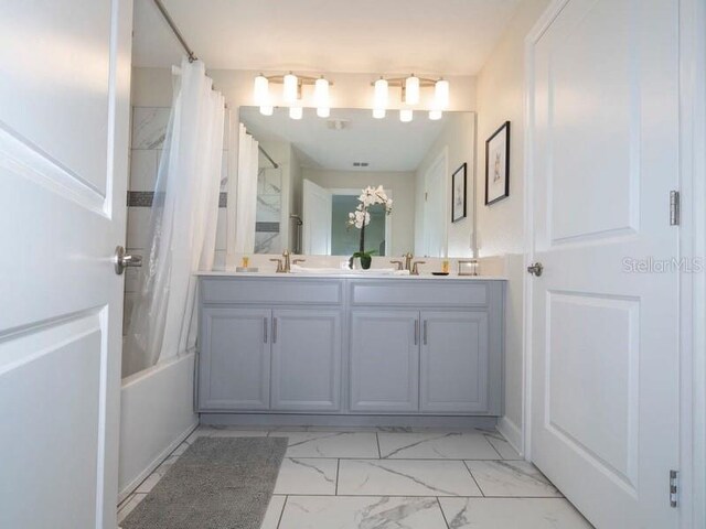 428 Ocean Course Ave, Davenport, FL 33896 - full bath with marble look tiles, double vanity, and shower / bath combo