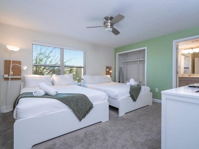 428 Ocean Course Ave, Davenport, FL 33896 - bedroom with a closet, carpet flooring, ceiling fan, baseboards, and ensuite bath
