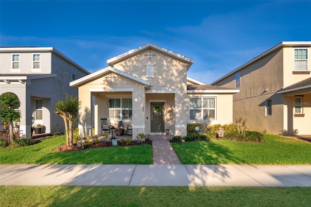 2289 Aloe Aly, Apopka, FL 32703 - view of front of house with covered porch, a front yard, and stucco siding