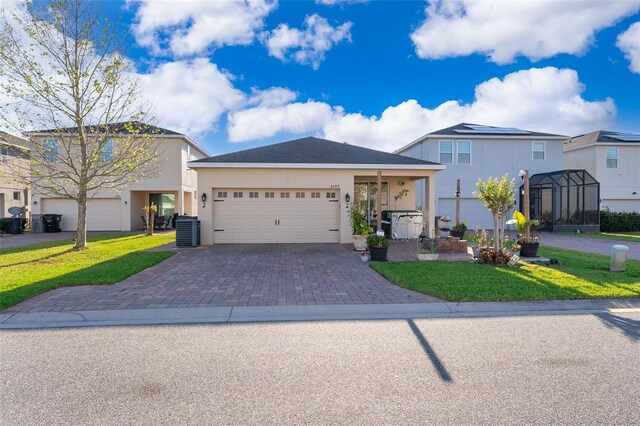 2289 Aloe Aly, Apopka, FL 32703 - view of front of house featuring stucco siding, an attached garage, decorative driveway, and a front yard