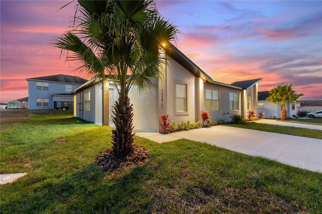 view of property exterior featuring stucco siding and a yard