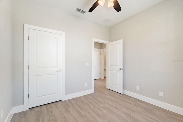 unfurnished bedroom with a ceiling fan, baseboards, light wood-style floors, and visible vents