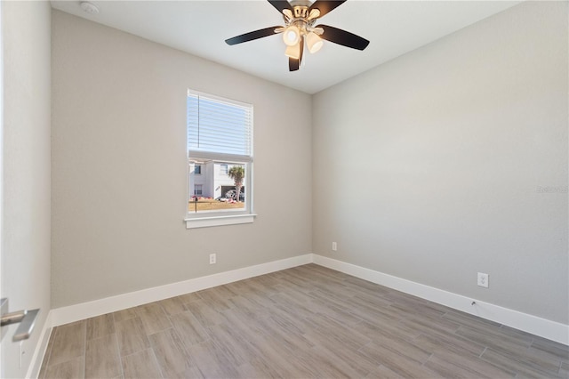 unfurnished room with baseboards, ceiling fan, and wood finished floors