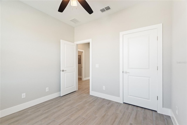 unfurnished bedroom featuring light wood-type flooring, baseboards, and visible vents