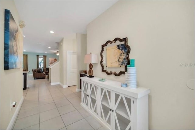 corridor with light tile patterned flooring, baseboards, and recessed lighting