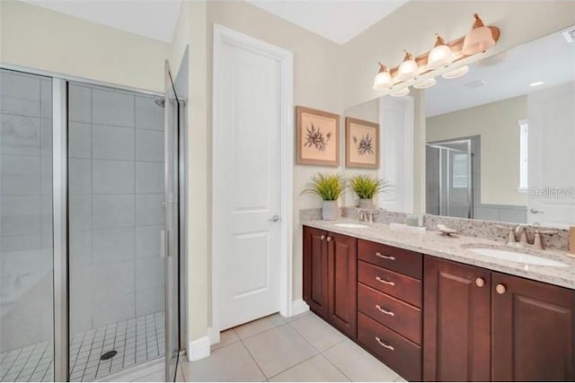 full bath with tile patterned floors, a sink, double vanity, and a shower stall