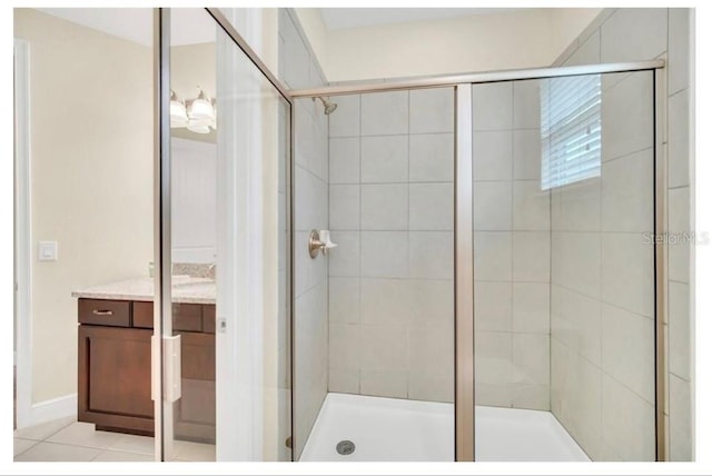 full bathroom with a shower stall, tile patterned flooring, and vanity