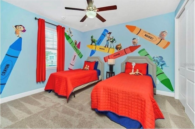 carpeted bedroom with baseboards, ceiling fan, and a closet
