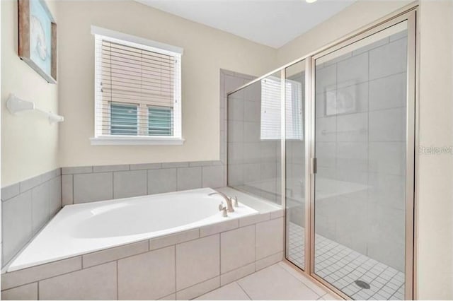 full bathroom with a stall shower, tile patterned floors, and a bath