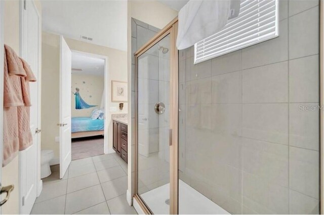 ensuite bathroom with ensuite bath, toilet, a stall shower, and tile patterned floors