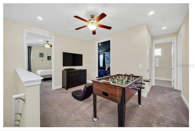 recreation room with baseboards, carpet flooring, and a ceiling fan