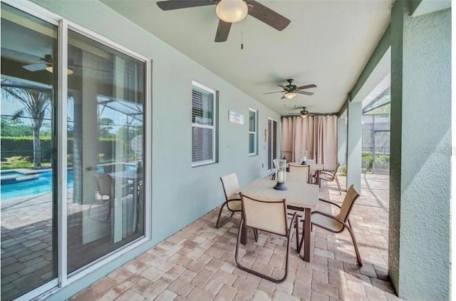 sunroom / solarium featuring brick floor
